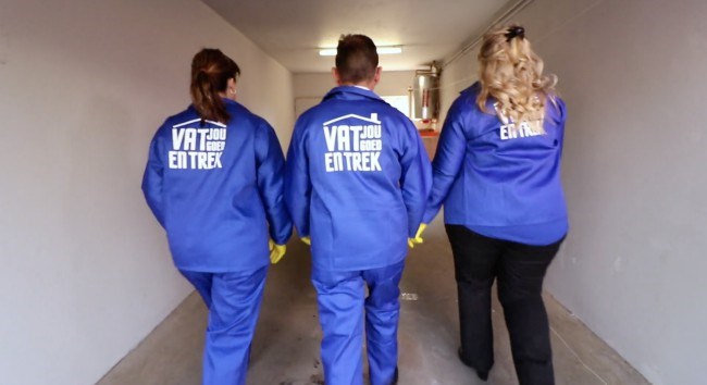 Estate agents showing off their Vat Jou Goed en Trek overalls for the renovation challenge
