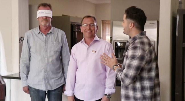 man blindfolded waiting for the big reveal of his home renovation