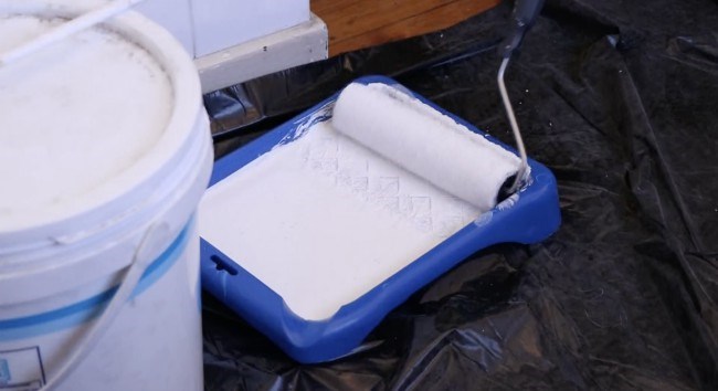 White tray of paint with floor covering