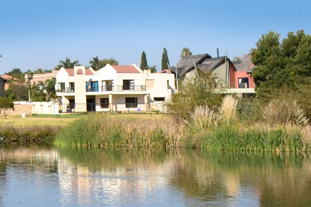 Homes overlooking a lake in Kempton Park